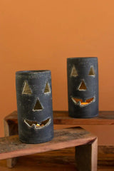 close up of 2 black jack-o-lanterns