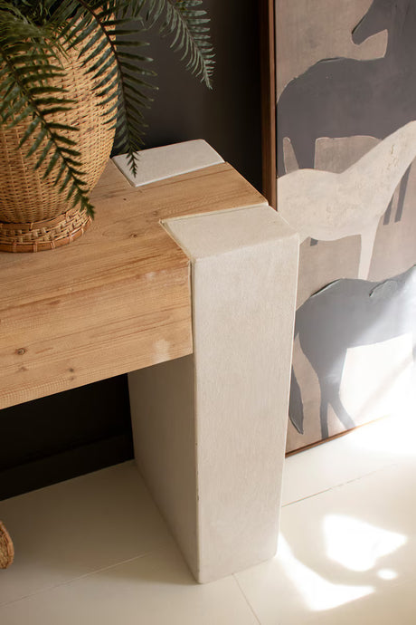 Close-up of right corner of wood surface console with a plant