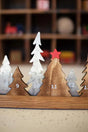 alternating wood and metal christmas trees - each counts a day towards december advent with a movable red star - close up view of 5 trees ~ days