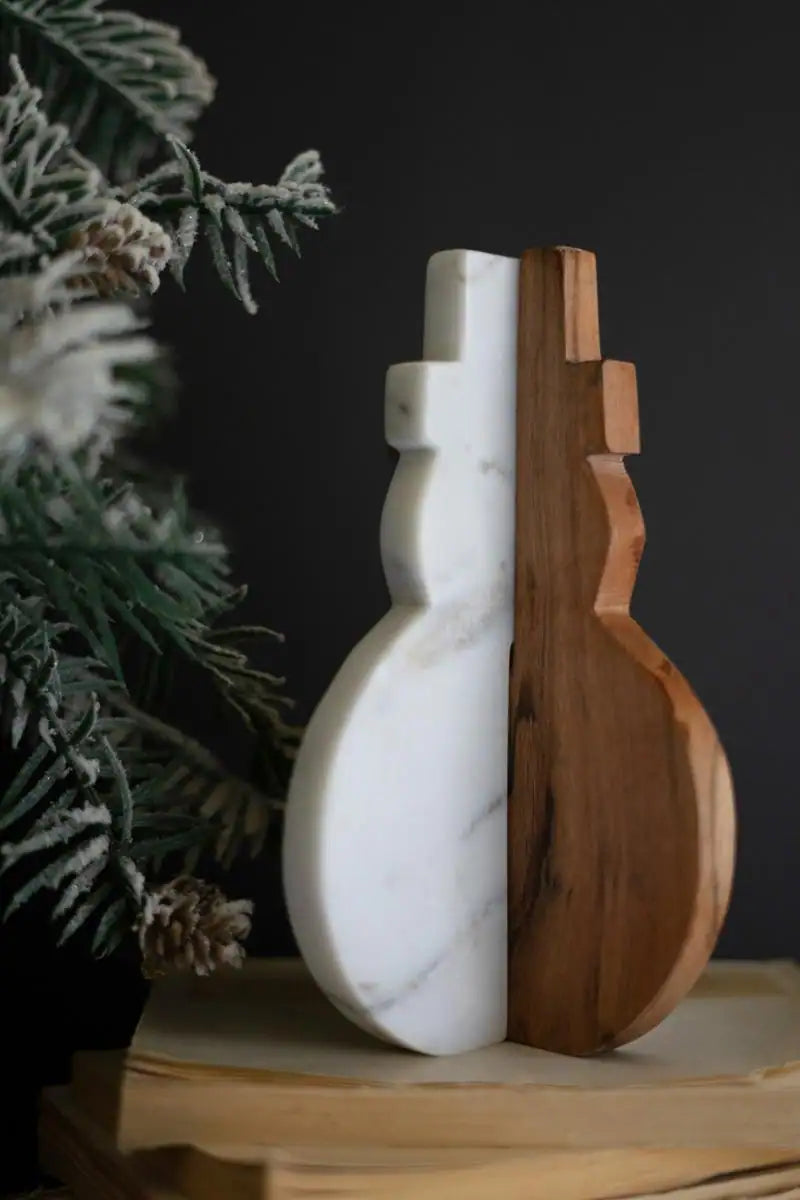 white marble and warm brown wood snowman