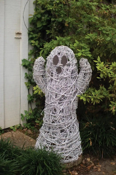 white twig ghost with its arms up - halloween decor