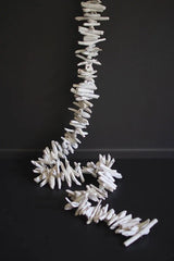 off white driftwood garland in front of dark gray background