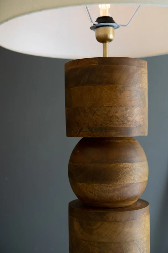 wood column floor lamp off white lamp shade - top of base and lamp shade close-up