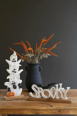 prop shoot of 3 ghosts also showing a carved spooky sign and a black vase with faux plants - the latter 2 sold separately