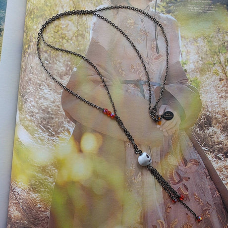 long bohemian gunmetal wire necklace with small skull pendant