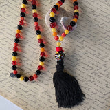 long bohemian style necklace made with color beads tibetan silver waxed cord and a nylon tassel