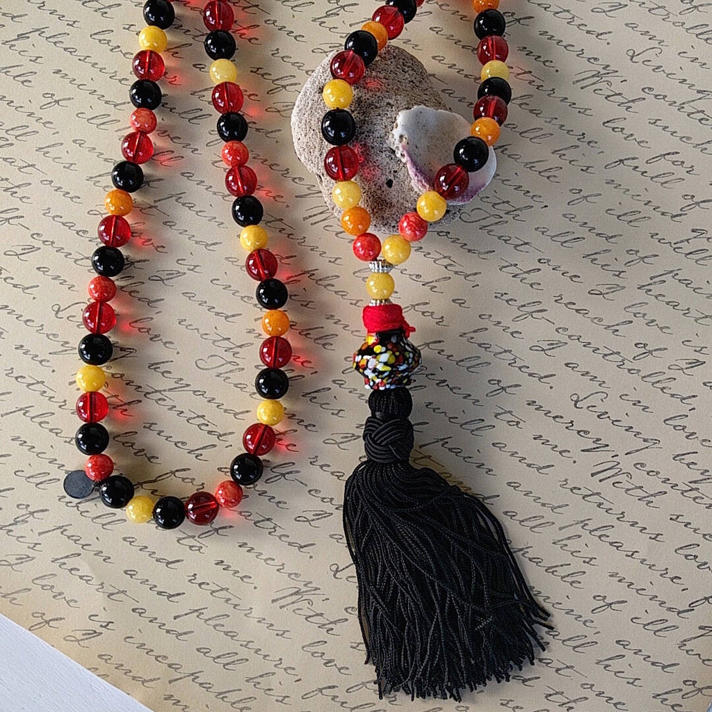 long bohemian style necklace made with color beads tibetan silver waxed cord and a nylon tassel