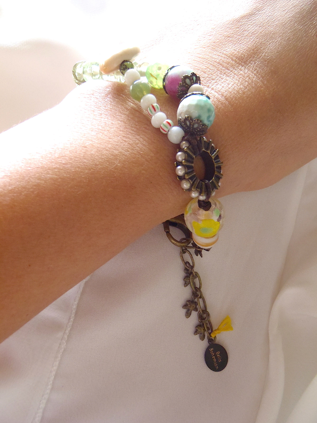handmade bracelet with lamp work glass as seen worn on a lady's wrist
