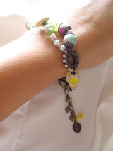 handmade bracelet with lamp work glass as seen worn on a lady's wrist