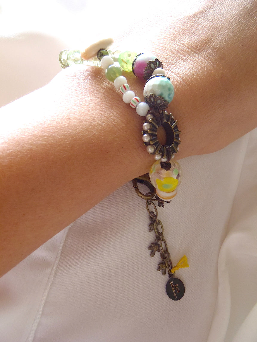 handmade bracelet with lamp work glass as seen worn on a lady's wrist
