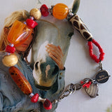handmade bracelet on black waxed thread with African amber beads, red corals, round ivory bone beads, Ghana colored seed beads