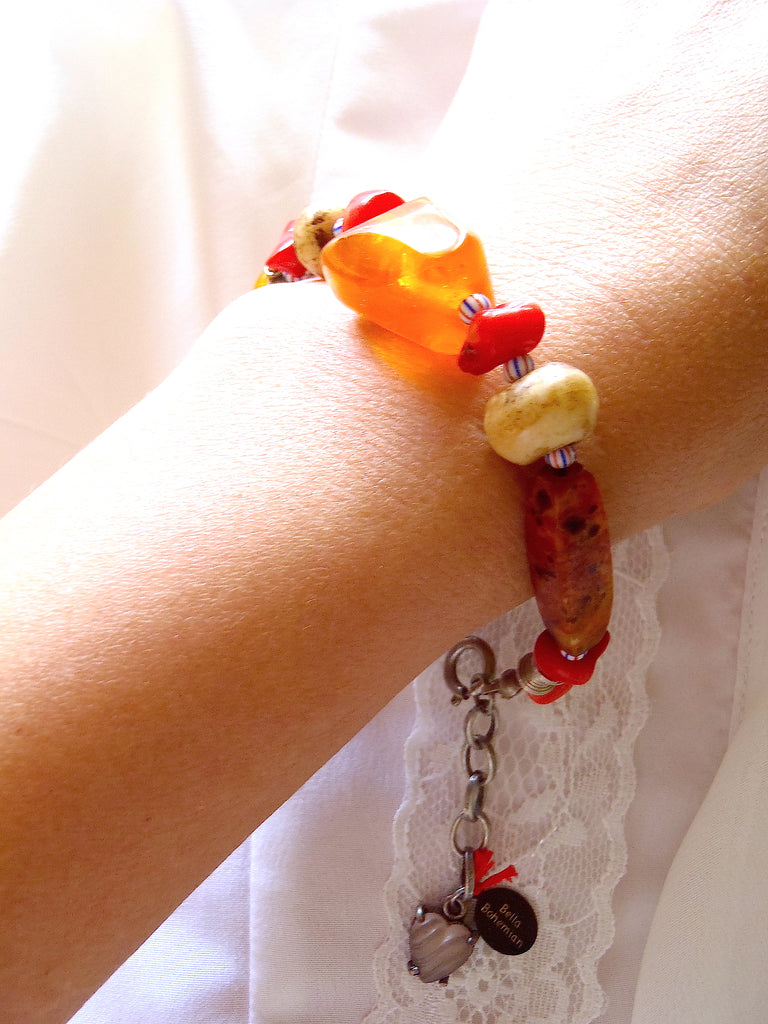 handmade bracelet on black waxed thread with African amber beads shown on a lady's wrist