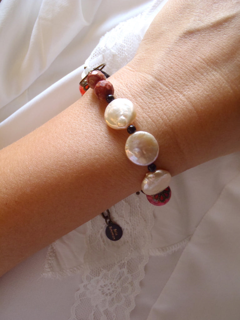 handmade bracelet with faceted pink agate and coin pearls shown on a lady's wrist