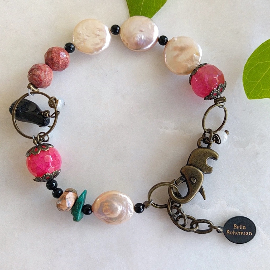 handmade bracelet with faceted pink agate, coin pearls, round black jasper, fancy brass caps, turquoise chips, and faceted brown jade