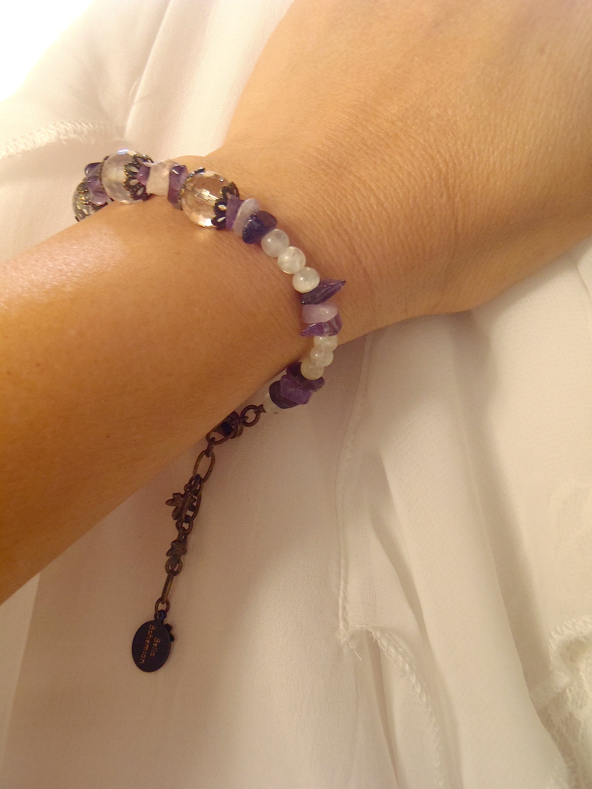 handmade bracelet using small irregular amethyst chips shown as worn on a lady's wrist