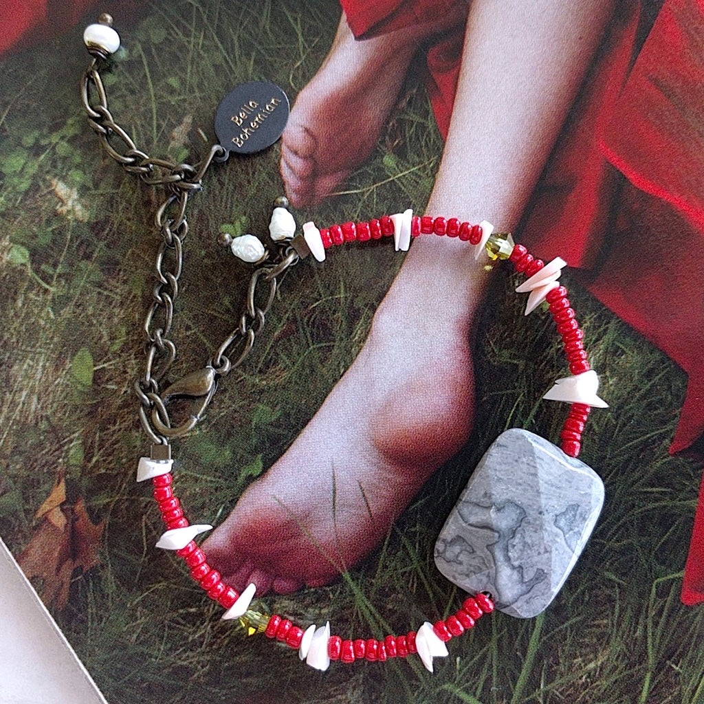 handmade friendship bracelet with red Indian seed beads, white coral chips, tiny green Swarovski beads