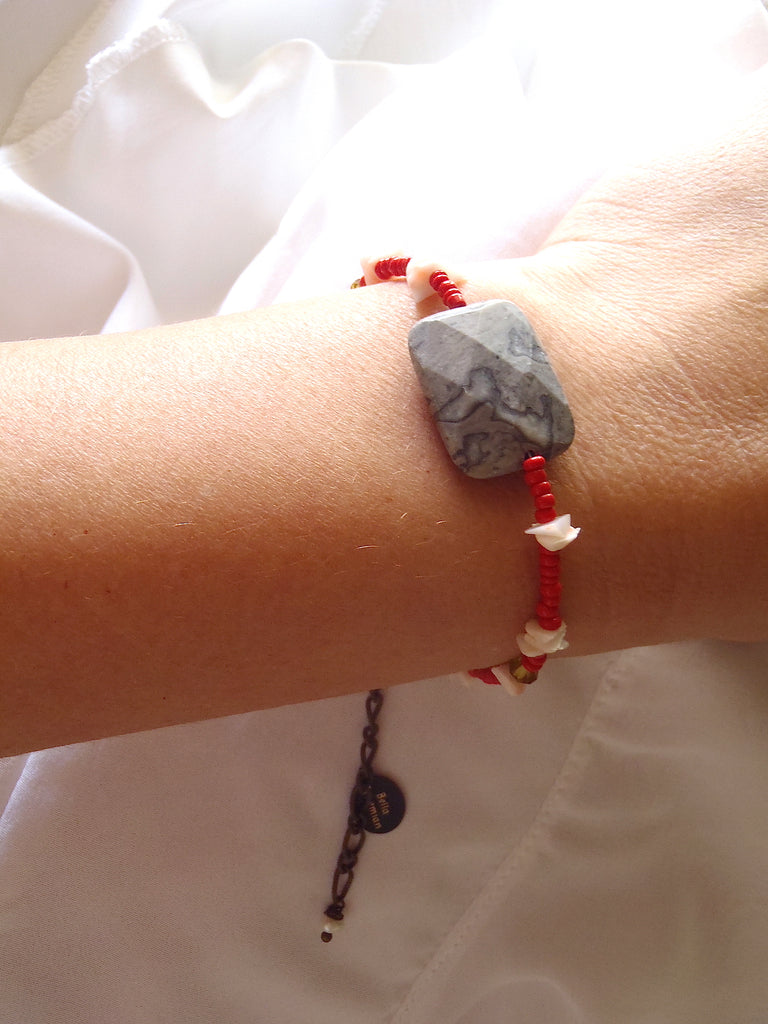 handmade friendship bracelet with red Indian seed beads shown worn on a lady's wrist