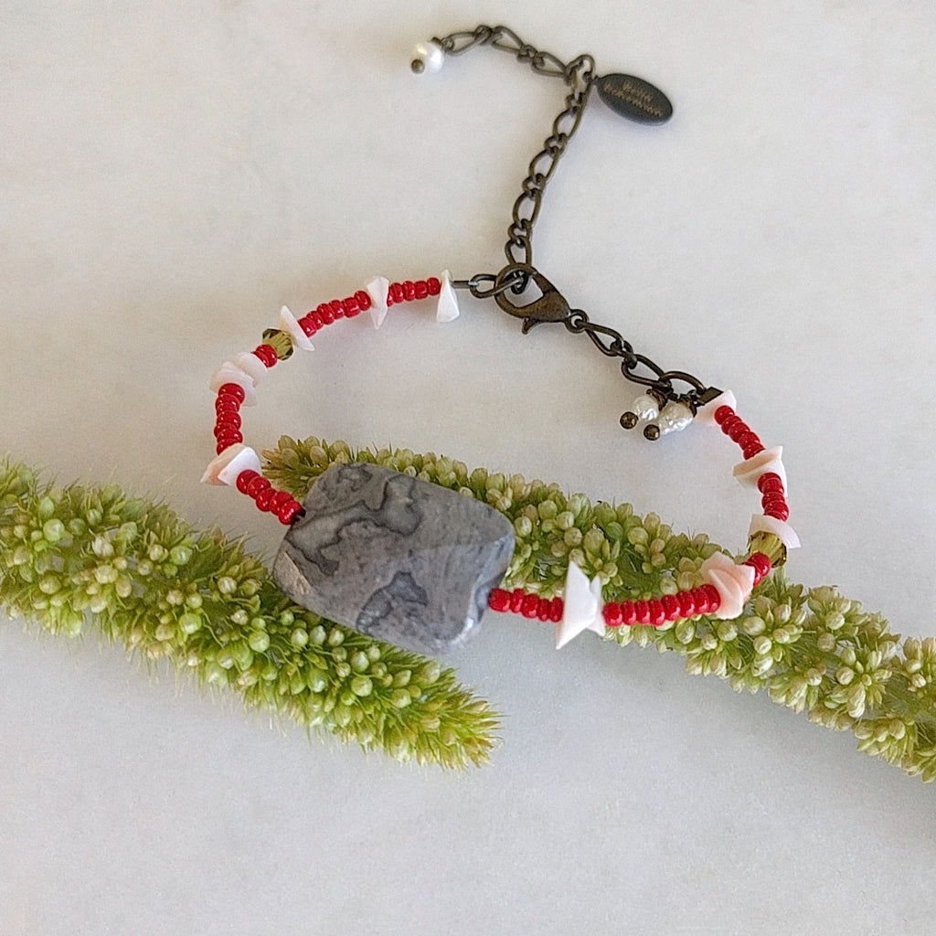 handmade friendship bracelet with red Indian seed beads, white coral chips, tiny green Swarovski beads and lobster clasp