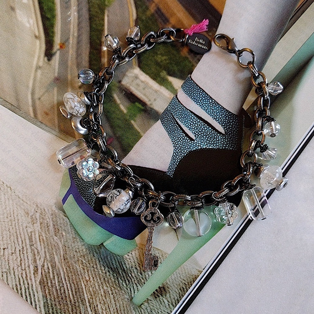 handmade bracelet with white translucent glass charms on alternate background
