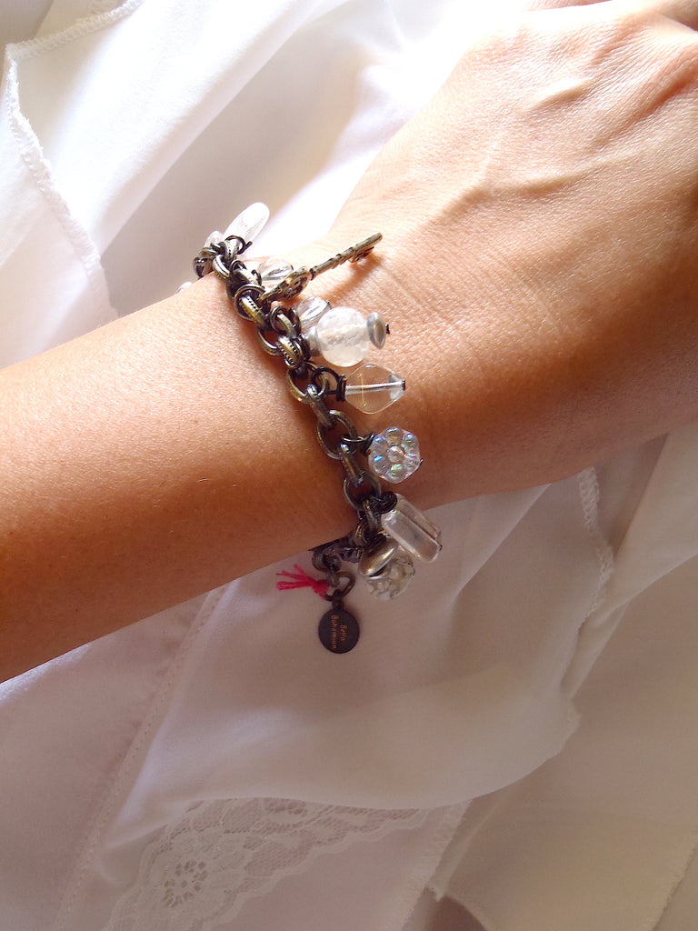 handmade bracelet with white translucent glass charms seen on a lady's wrist