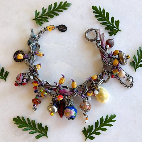 handmade bracelet with dyed dark and light purple sari silk, and then hand-wrapped between the chain