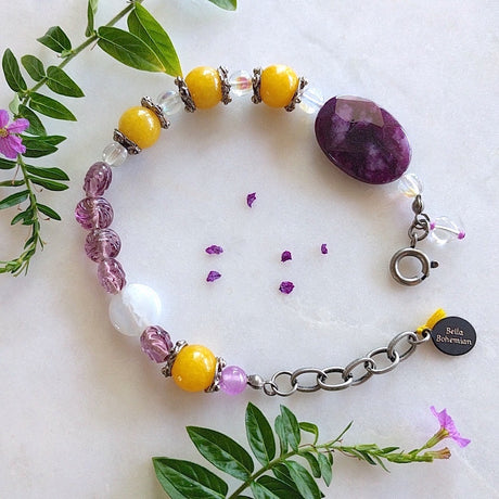 braclet with combination of yellow round jade, purple glass bead, clear Czech glass beads, a large faceted purple amethyst