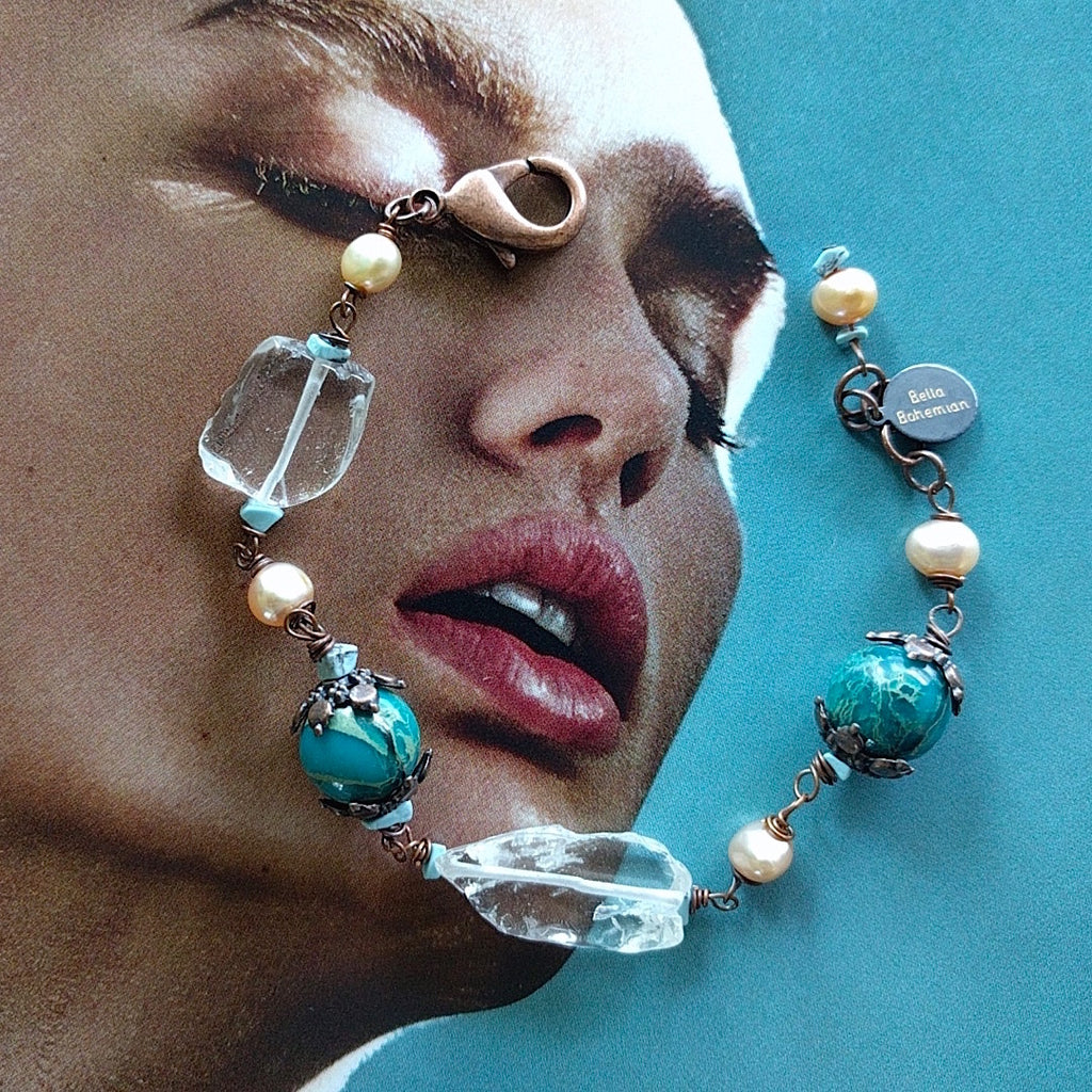 bracelet with creme color fresh water pearls, irregular glass beads, dyed serpentine jasper aqua round beads on alternate background