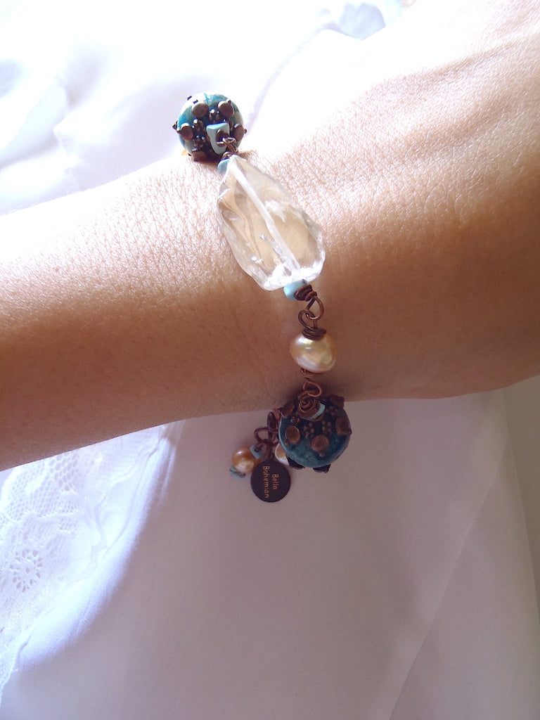 bracelet with fresh water pearls, irregular glass beads, dyed serpentine jasper aqua round beads shown on a lady's wrist
