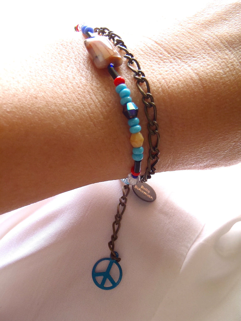 handmade friendship bracelets with colors of blue red amber and clear beads on a lady's wrist