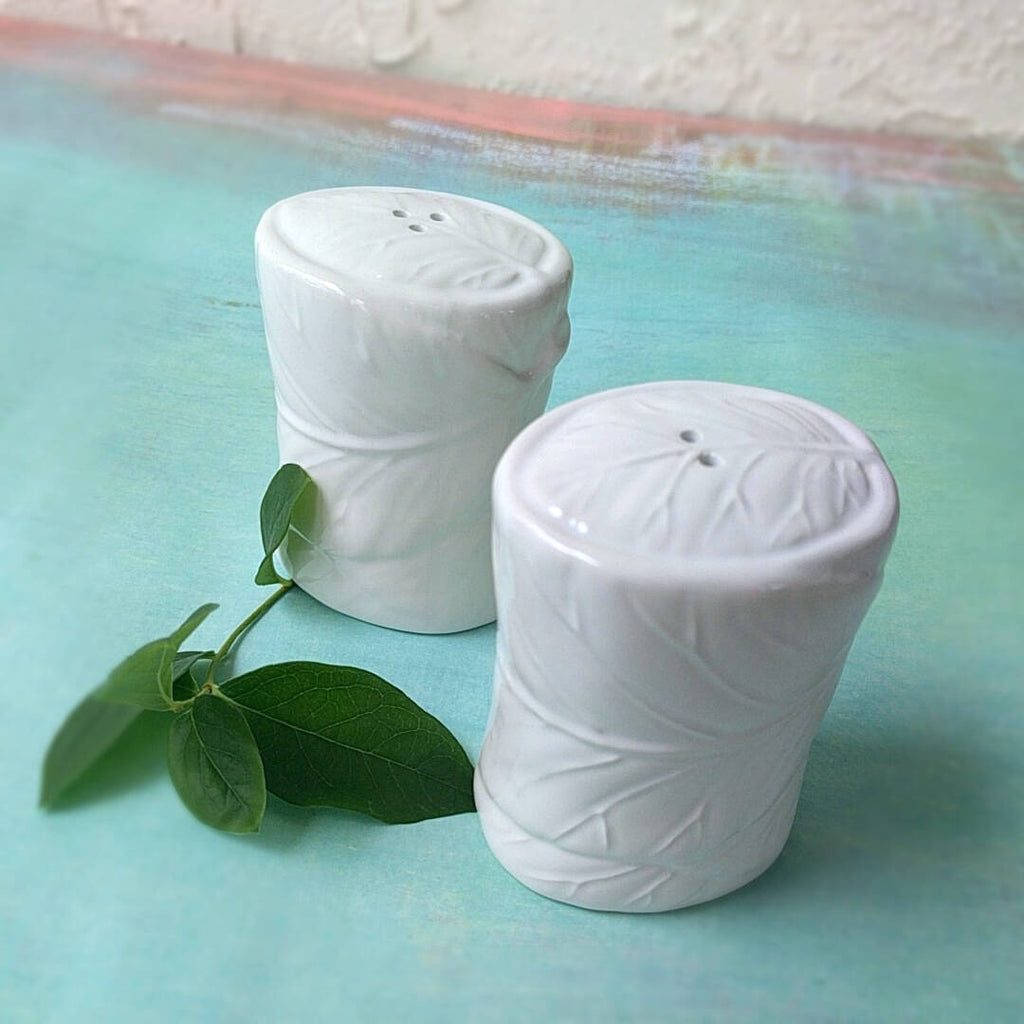 white ceramic set of salt and pepper shakers