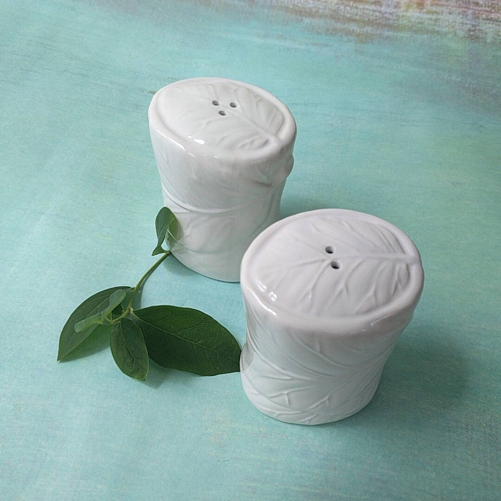white ceramic set of salt and pepper shakers (2)