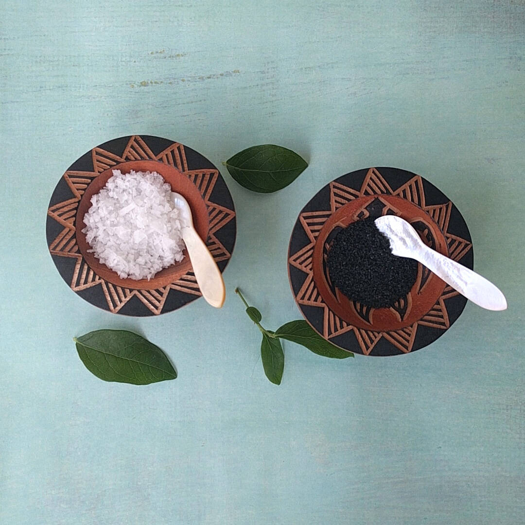 hand carved Fijian light wood salt and pepper cellars shown with salt and pepper - top view