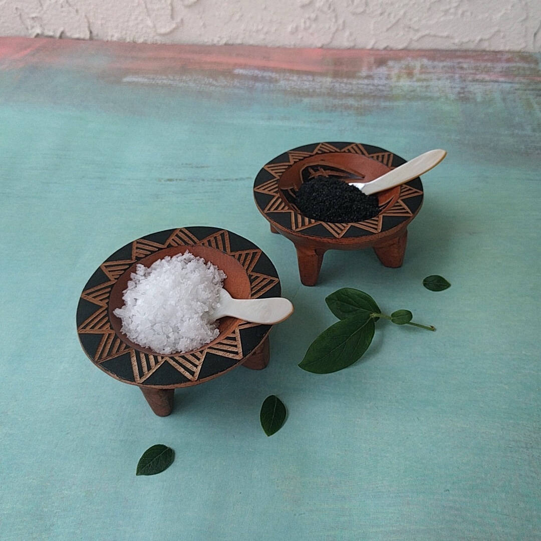 hand carved Fijian light wood salt and pepper cellars shown with salt and pepper - side view