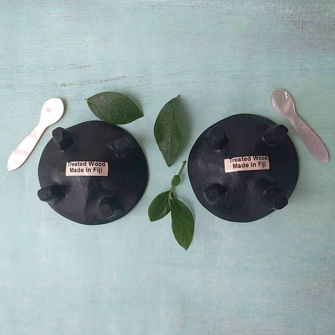 Fijian dark wood salt and pepper cellars shown with two mother-of-pearl spoons - bottom view