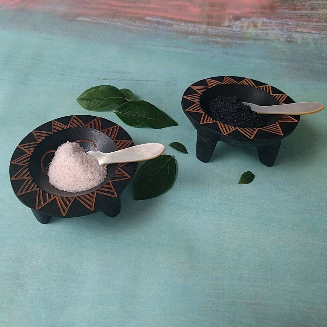 hand carved Fijian dark wood salt and pepper cellars shown with salt and pepper - side view