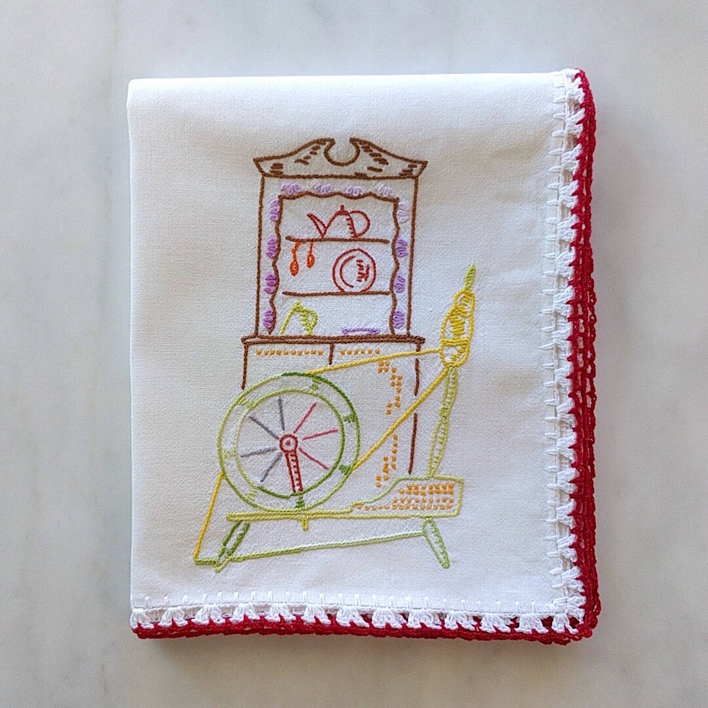 oversized white cotton tea towel with multicolored spinning wheel motif
