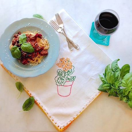 handmade white cotton kitchen towel with red pot and orange flower motif