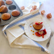 cream colored cotton tea towel with blue stripe