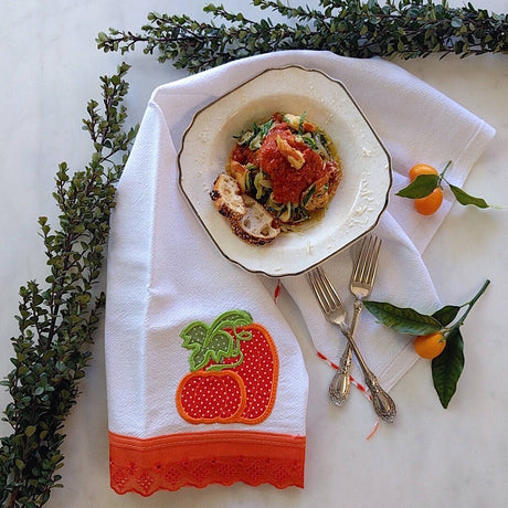 white tea towel with dark orange color strawberry machine embroidered and hemmed