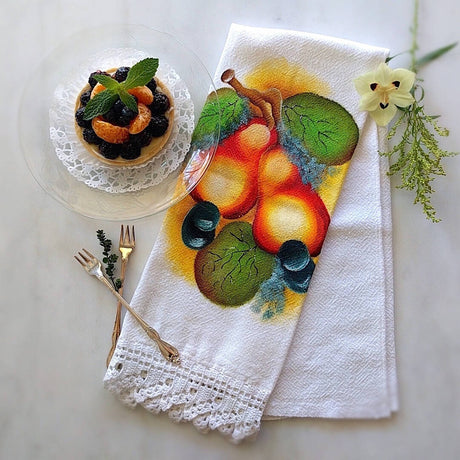 white cotton tea towel with pear motif and a white hand crocheted border