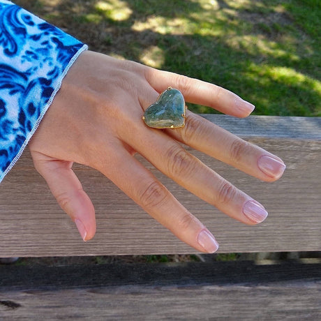 heart-shaped green Quartz cocktail ring on a lady's hand