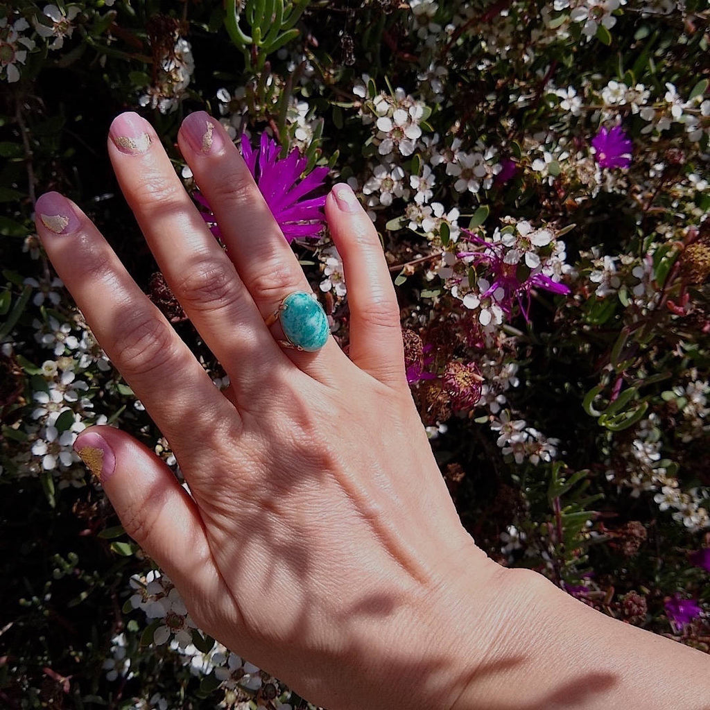 top down view of green amazonite cocktail ring worn on a lady's hand