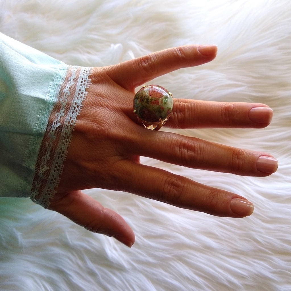 unakite gold-plated cocktail ring with unusual reddish brown color on a lady's hand