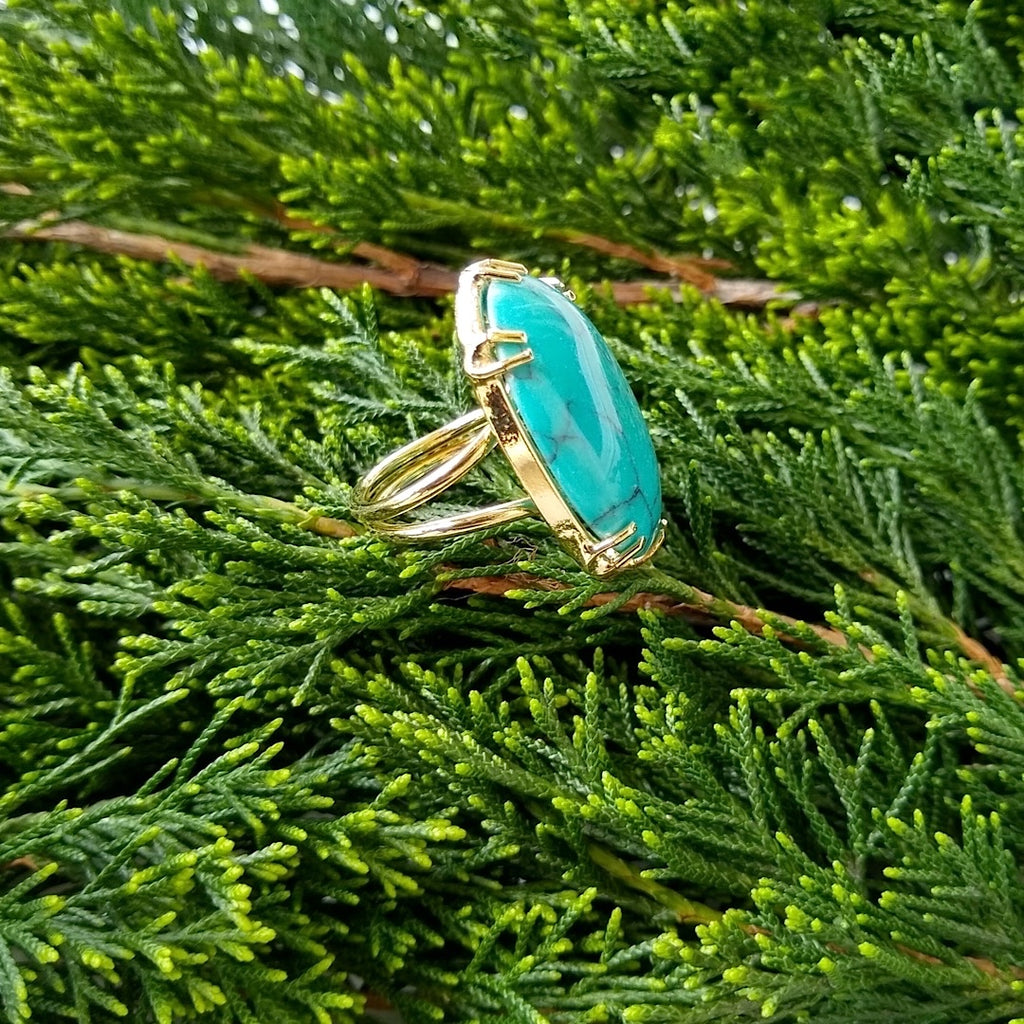 side view of oval turquoise adjustable gold-plated cocktail ring
