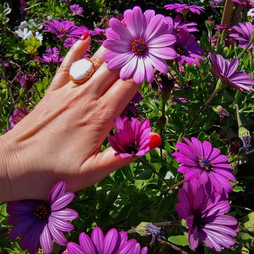 round Milky Crystal adjustable gold-plated cocktail ring on a lady's hand
