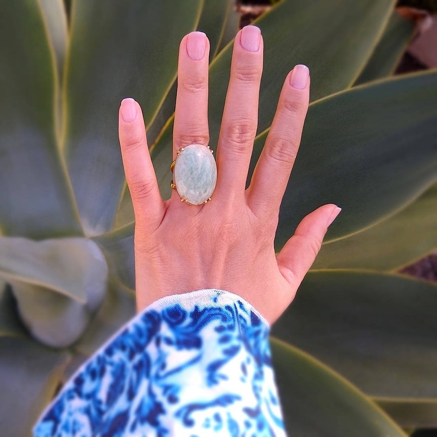 top down view of oval amazonite gold-plated cocktail ring on a lady's hand