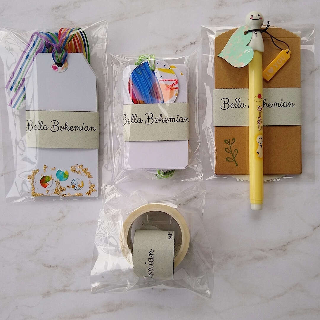 confetti and gold foil gift cards, white gift tags, mini envelopes, Japanese washi tape, Japanese sunny doll black pen laid out and plastic wrapped