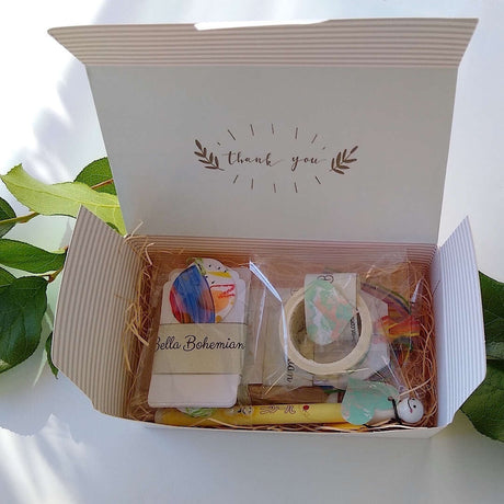 confetti and gold foil gift cards, white gift tags, mini envelopes, Japanese washi tape, Japanese sunny doll black pen all plastic wrapped, positioned in gift box ready to ship