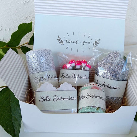 silver luxe glitter gift cards, white hang tags, German cotton spun mushrooms, metallic glitter bakers twine, plastic wrapped standing in gift box