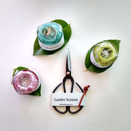 farmhouse rustic black scissors with three balls of jute twine in colors lavender, light green and soft blue